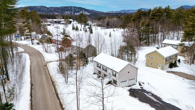 snowy aerial view featuring a mountain view