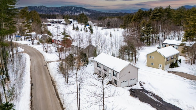 snowy aerial view with a mountain view