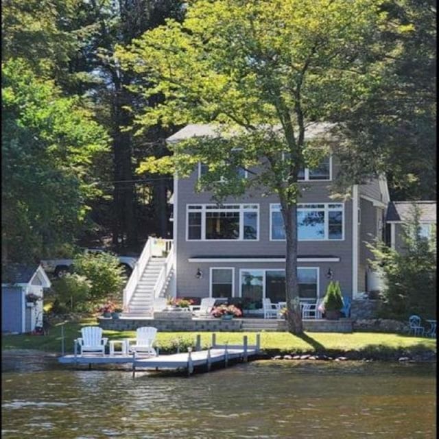 back of house featuring stairs and a water view