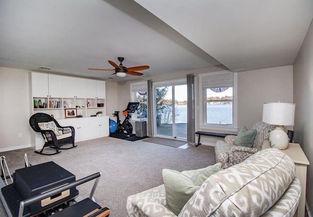 living room featuring ceiling fan, carpet floors, visible vents, and baseboards