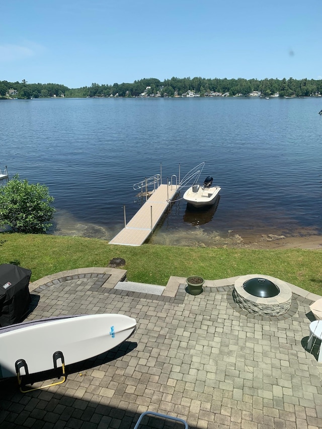 dock area featuring a water view and a fire pit