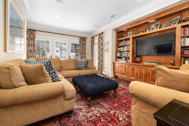 living area with ornamental molding, built in shelves, and wood finished floors