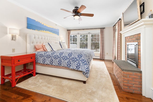 bedroom featuring ornamental molding, a ceiling fan, baseboards, and wood finished floors