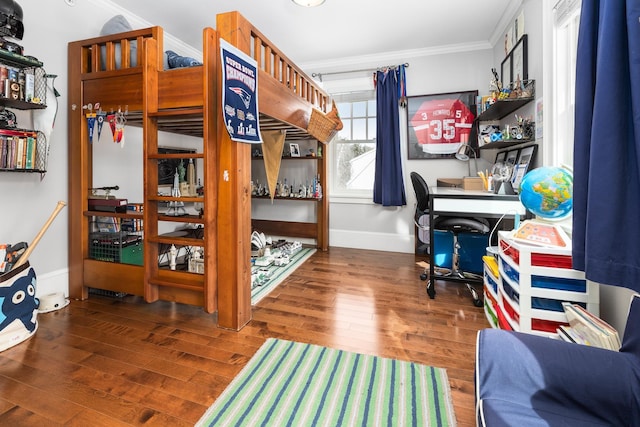 bedroom featuring baseboards, dark wood-style flooring, and crown molding