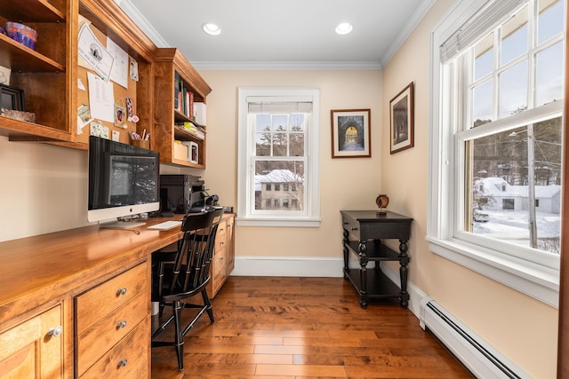 office space featuring plenty of natural light, ornamental molding, a baseboard radiator, and built in desk