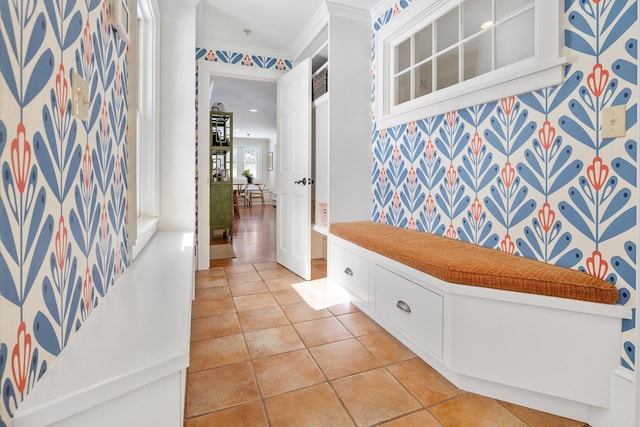 mudroom featuring crown molding and light tile patterned flooring