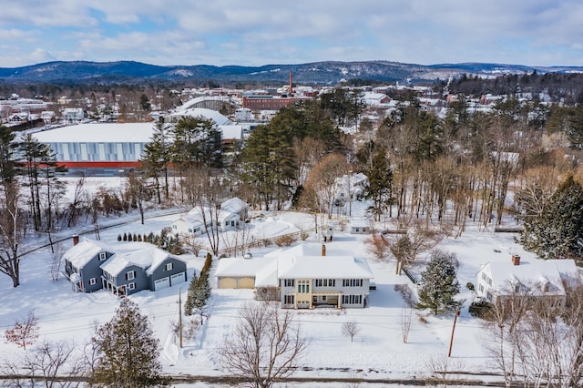 snowy aerial view featuring a mountain view