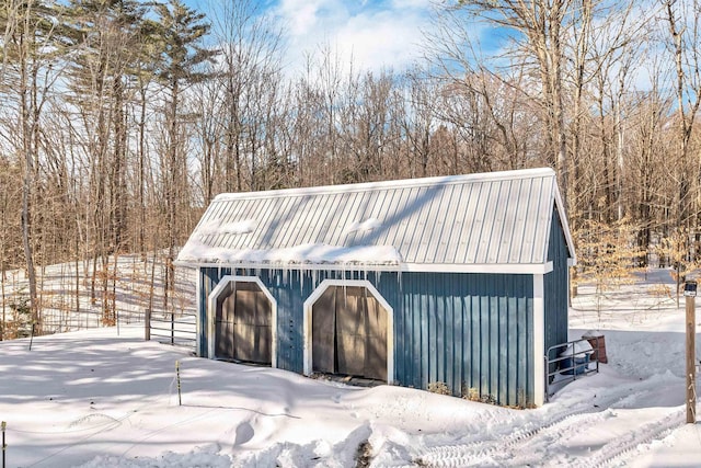 snow covered garage with a garage