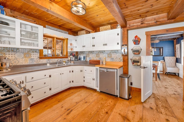 kitchen featuring white cabinets, dishwasher, stove, beam ceiling, and a sink