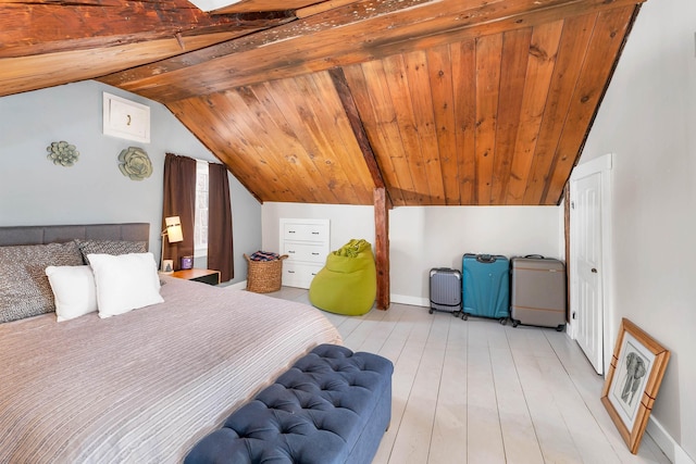 bedroom featuring lofted ceiling, wood ceiling, baseboards, and light wood finished floors