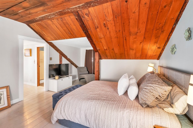 bedroom with lofted ceiling, wooden ceiling, light wood-style flooring, and baseboards