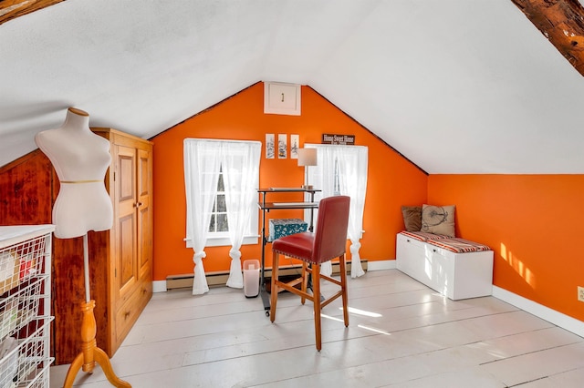 interior space with lofted ceiling, light wood finished floors, and baseboards