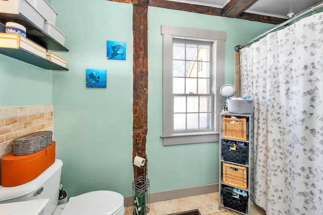 bathroom with baseboards, curtained shower, toilet, and tile patterned floors