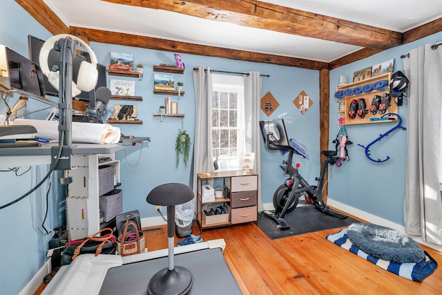 exercise area featuring light wood-style floors and baseboards