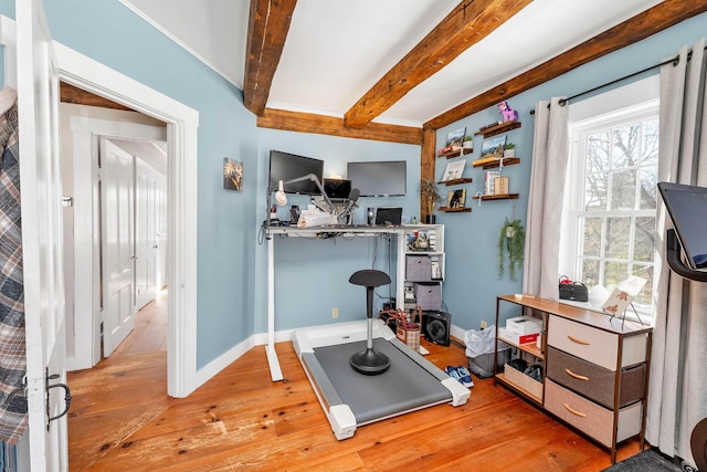 workout area featuring light wood-type flooring and baseboards