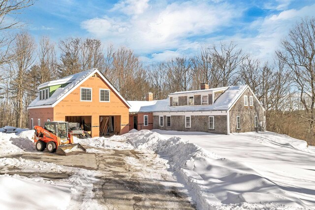 view of front of property with a garage and a chimney