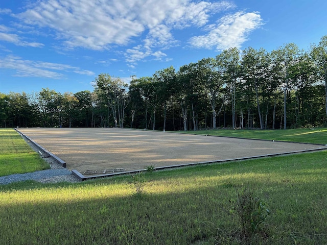 view of basketball court featuring a lawn