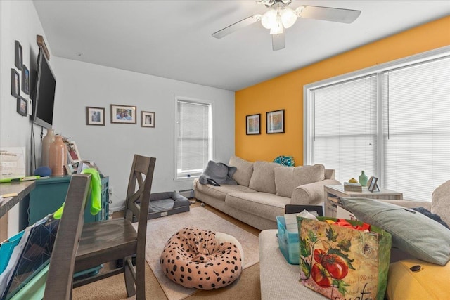 living area with ceiling fan and a baseboard radiator