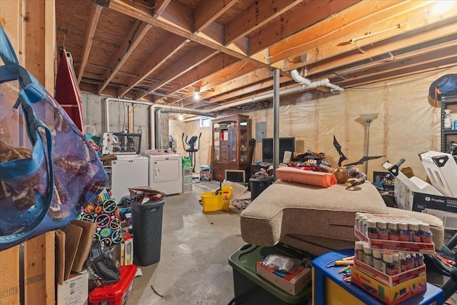 unfinished below grade area featuring washer and clothes dryer and electric panel