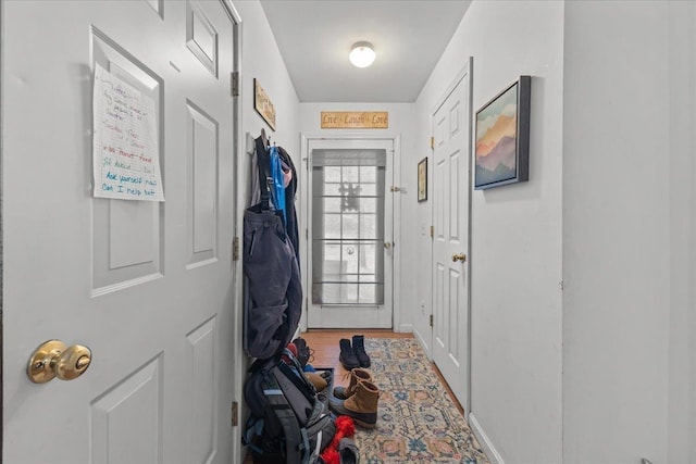 doorway to outside with baseboards