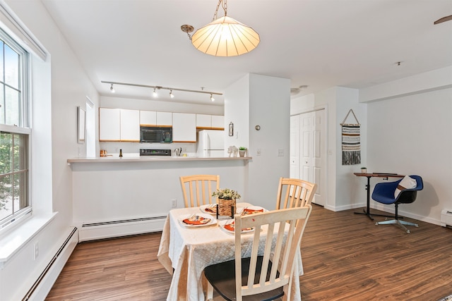 dining space featuring a baseboard radiator, dark wood finished floors, and baseboards