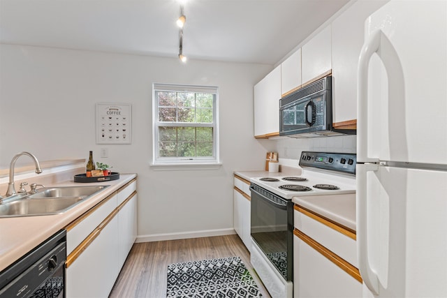 kitchen featuring light countertops, white cabinetry, a sink, and black appliances