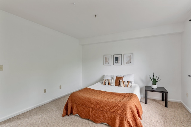 carpeted bedroom featuring baseboards