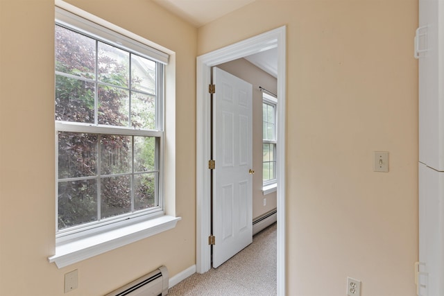 interior space featuring light carpet, baseboards, and baseboard heating