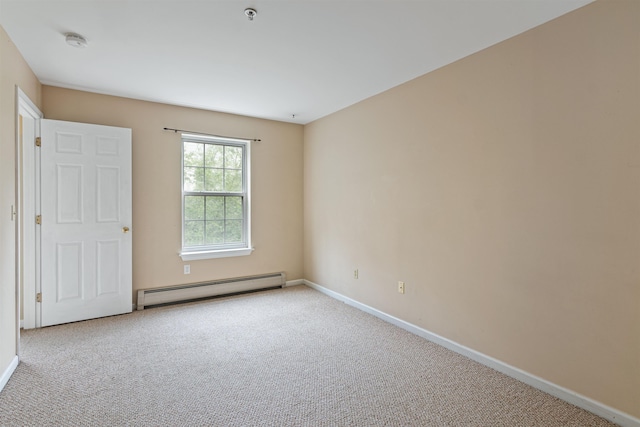 empty room featuring a baseboard heating unit, light carpet, and baseboards