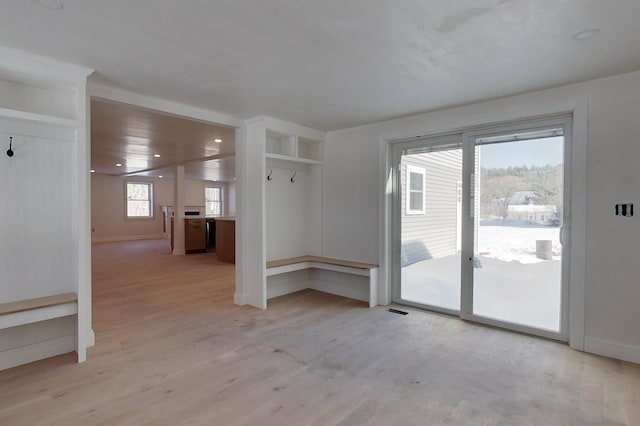 empty room featuring light wood-type flooring and baseboards