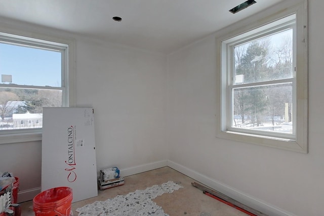 unfurnished room featuring baseboards