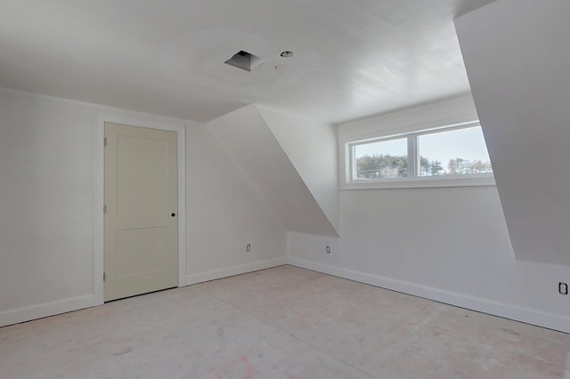 additional living space featuring baseboards