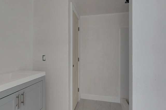 bathroom featuring baseboards and vanity