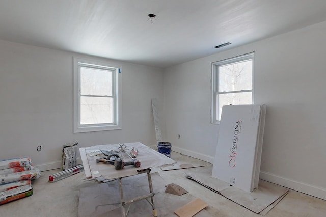 interior space with a wealth of natural light and baseboards