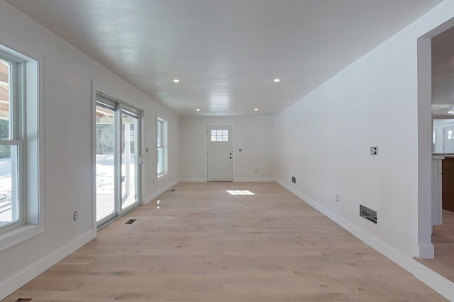 unfurnished living room featuring light wood-style flooring, baseboards, and recessed lighting