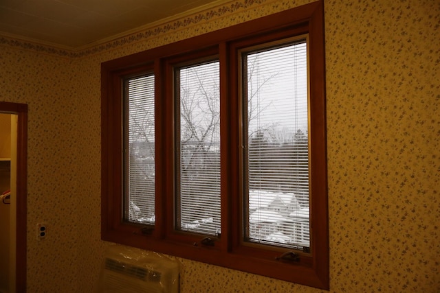 interior details with wallpapered walls, crown molding, and a wall mounted AC