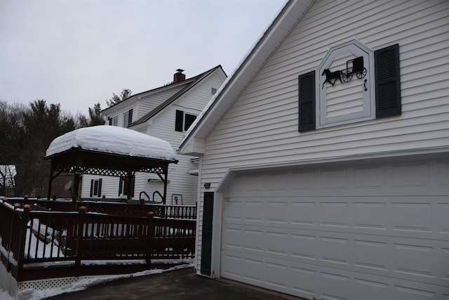 view of home's exterior featuring a gazebo, driveway, and a garage