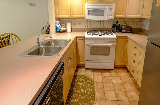 kitchen with light countertops, white appliances, light tile patterned flooring, and a sink