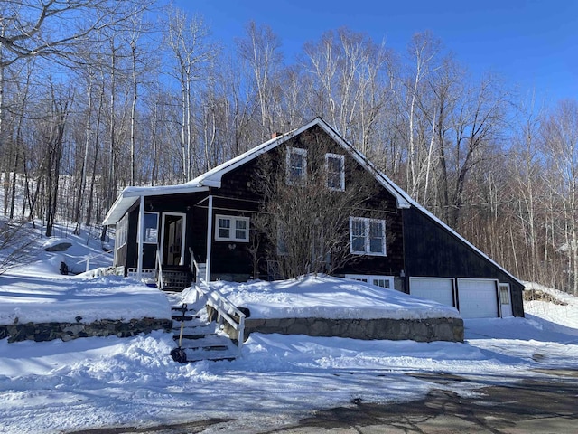 chalet / cabin with a detached garage