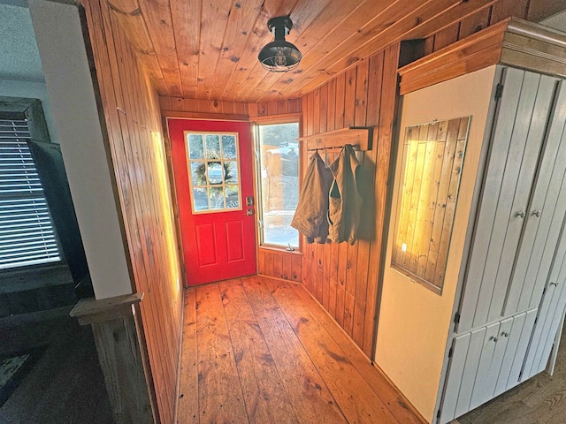 interior space with wood ceiling, wood walls, and wood finished floors