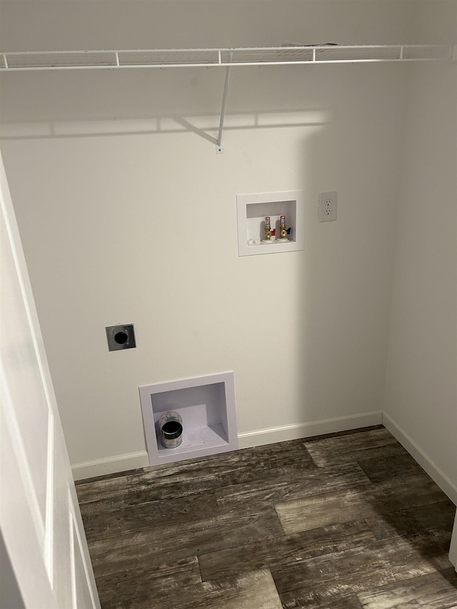 clothes washing area featuring dark wood-style floors, hookup for a washing machine, electric dryer hookup, laundry area, and baseboards