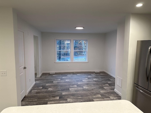 empty room with recessed lighting, visible vents, dark wood finished floors, and baseboards