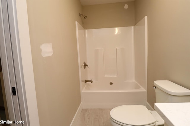 full bath featuring shower / washtub combination, baseboards, vanity, and toilet