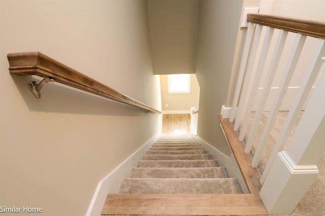 stairway featuring baseboards