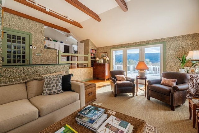 living area featuring vaulted ceiling with beams and wallpapered walls