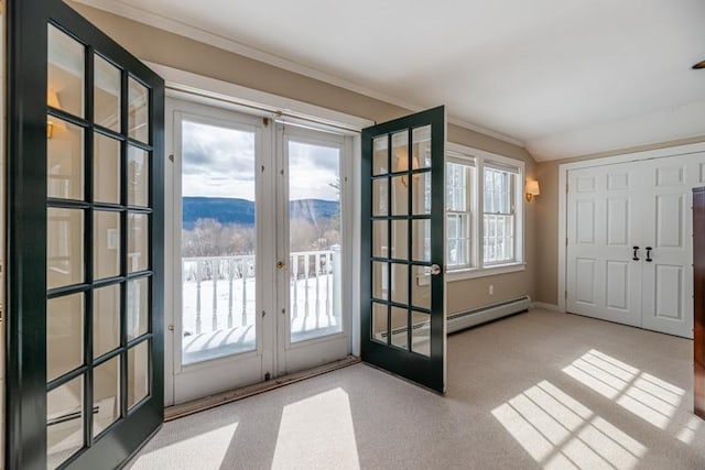 doorway to outside featuring french doors, crown molding, a baseboard heating unit, light carpet, and a mountain view