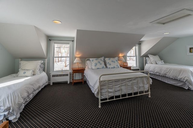 bedroom with radiator, attic access, multiple windows, and dark colored carpet