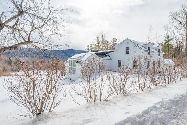 snow covered property with a mountain view