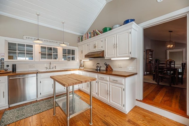 kitchen with hanging light fixtures, butcher block counters, white cabinetry, and stainless steel dishwasher