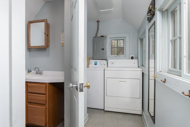 laundry room with a sink, washing machine and dryer, and electric panel